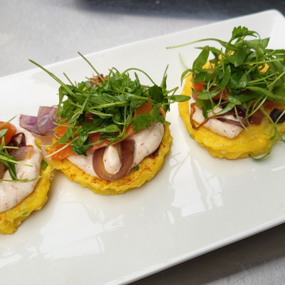 Corn Cakes with Tajin Sour Crema, Smoked Salmon, and Caramelized Red Onions